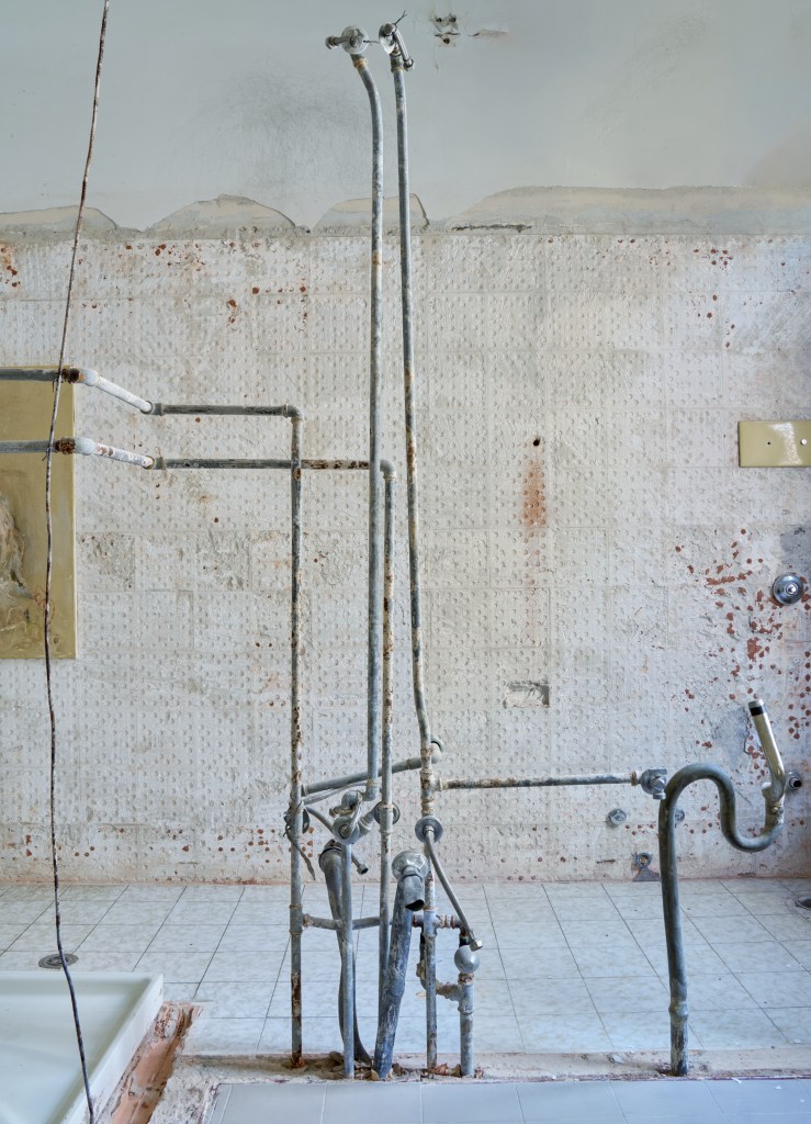 my emptiness (2025), site-specific installation using sectioned walls, excavated pipes, and a bathtub. Dimensions variable. The work suggests domestic exposure and vulnerability through architectural dissection.