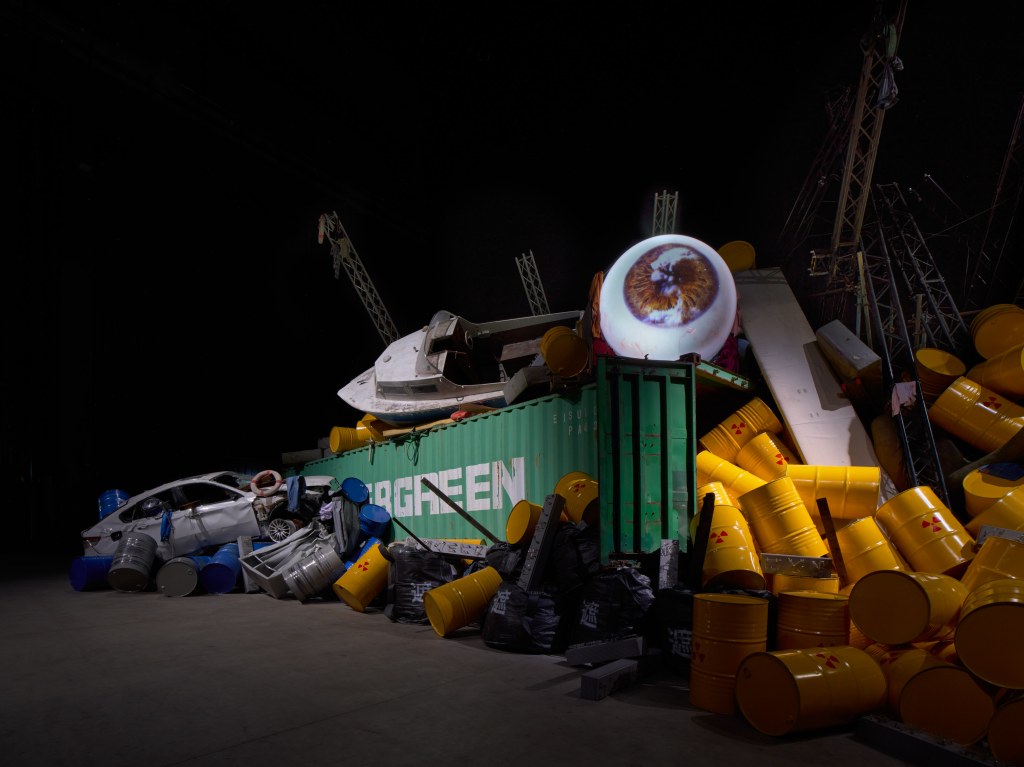 Exhibition view of Yukinori Yanagi’s ICARUS at Pirelli HangarBicocca, Milan, 2025. In the foreground, the work Article 9 (1994); in the background, Project Godzilla 2025: The Revenant from “El Mare Pacificum” (2025). ©YANAGI STUDIO. Courtesy of the artist and Pirelli HangarBicocca. Photo by Agostino Osio.