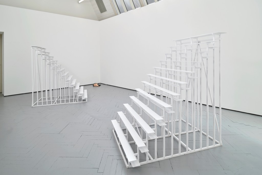 Bleacher (2025) by Esther Gamsu, constructed from wood, PVA, and gloss paint. The work evokes the form of tiered seating, blending minimalist structure with a polished, reflective finish.