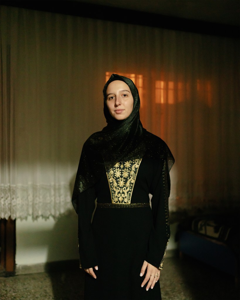 A woman smiles on her wedding day in Gaziantep, Turkey, dressed in a traditional Syrian bridal gown. Photo by Carola Cappellari, 2021.