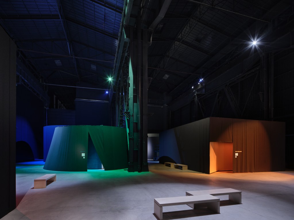 Installation views of This Will Not End Well by Nan Goldin at Pirelli HangarBicocca, Milan, 2025, showing cinematic projections within a darkened exhibition environment. Photo by Agostino Osio