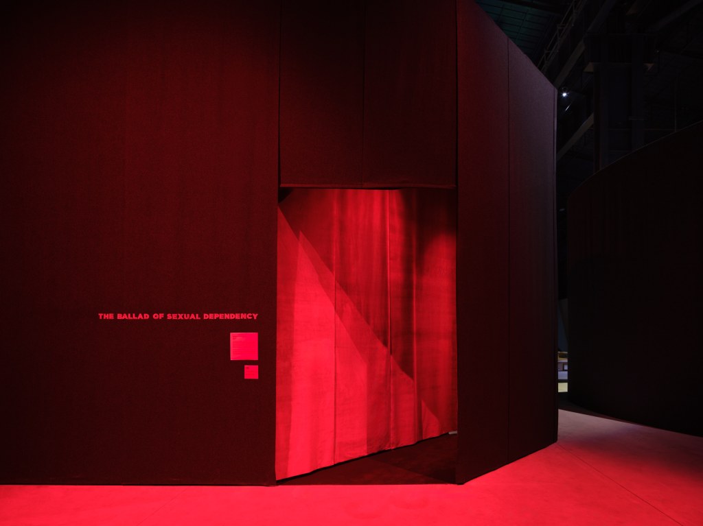 Installation views of This Will Not End Well by Nan Goldin at Pirelli HangarBicocca, Milan, 2025, showing cinematic projections within a darkened exhibition environment. Photo by Agostino Osio