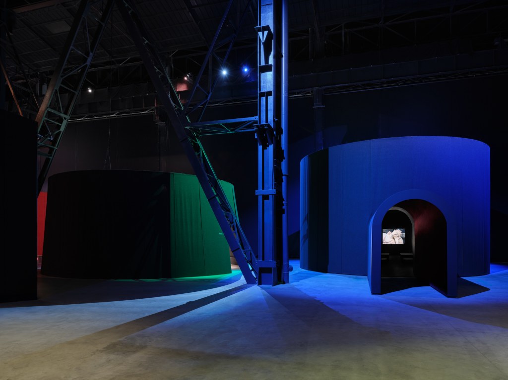 Installation views of This Will Not End Well by Nan Goldin at Pirelli HangarBicocca, Milan, 2025, showing cinematic projections within a darkened exhibition environment. Photo by Agostino Osio