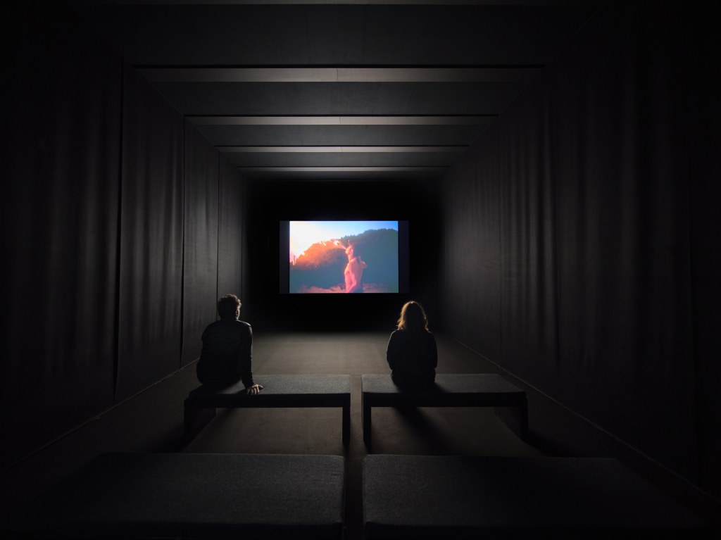 Installation view of Memory Lost, a multi-screen video work by Nan Goldin presented in a darkened exhibition space at Pirelli HangarBicocca, Milan, 2025. Photo by Agostino Osio
