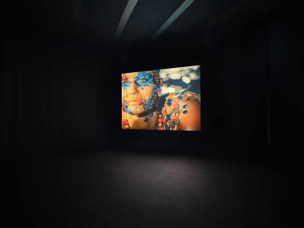 View of Sirens by Nan Goldin, featuring immersive projected imagery within a dark gallery at Pirelli HangarBicocca, Milan, 2025. Photo by Agostino Osio