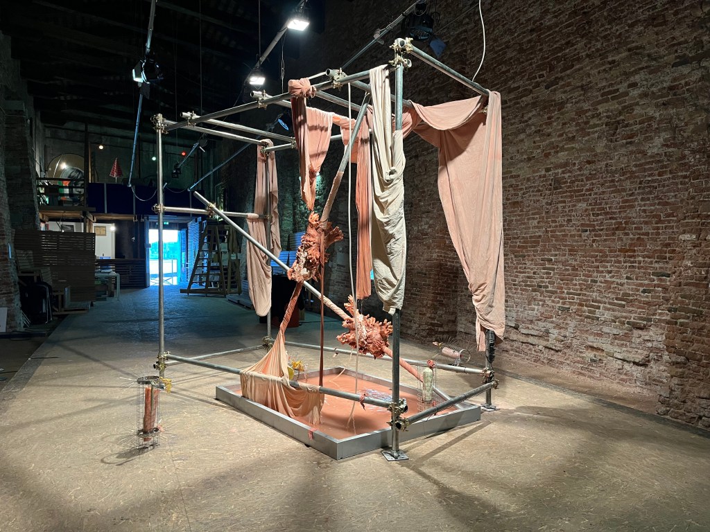 Installation view of No body makes its own bodies (2025) by Chen Chen YU at S.a.L.E. Docks, Venice, showing sculptural and spatial elements arranged within the industrial gallery space. Photo by Rebecca Canavesi