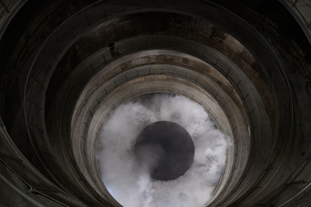 Installation view of Carlos Casas’s sound work 1883/Krakatoa at the 13th Shanghai Biennale, featuring a darkened gallery space with minimal visual elements designed to immerse visitors in a continuous sound environment.