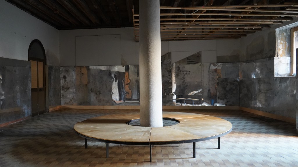 Interior view of the former infirmary, showing spacious rooms, architectural details, and signs of past use.