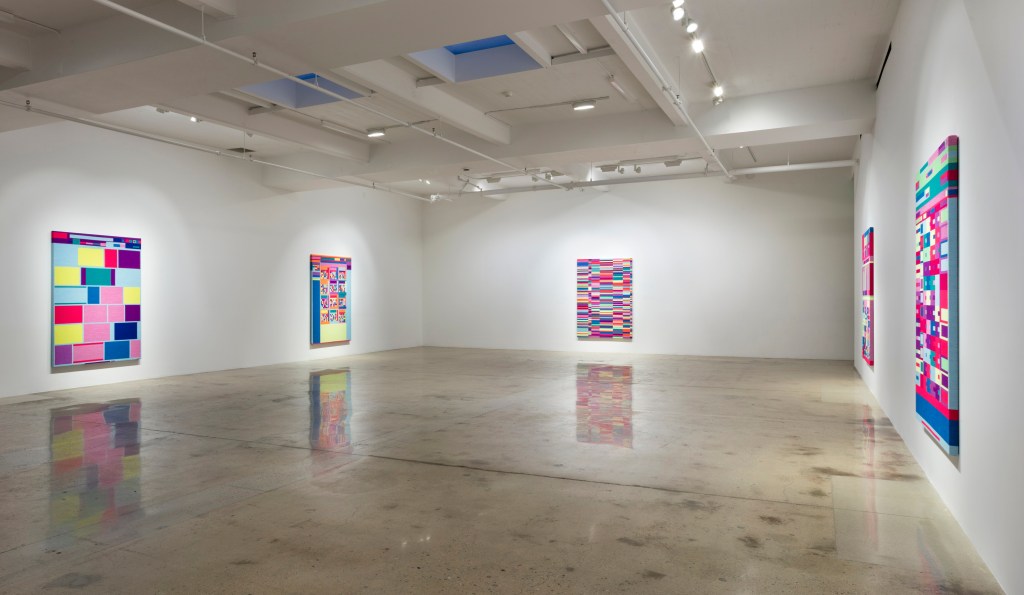 Exhibition view of Portraits by Rafaël Rozendaal, presenting a series of abstract, brightly colored digital works arranged along white gallery walls.