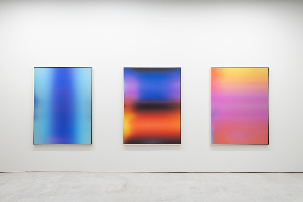 Exhibition view of Screen Time in Tokyo, where luminous digital works are integrated into the gallery architecture.