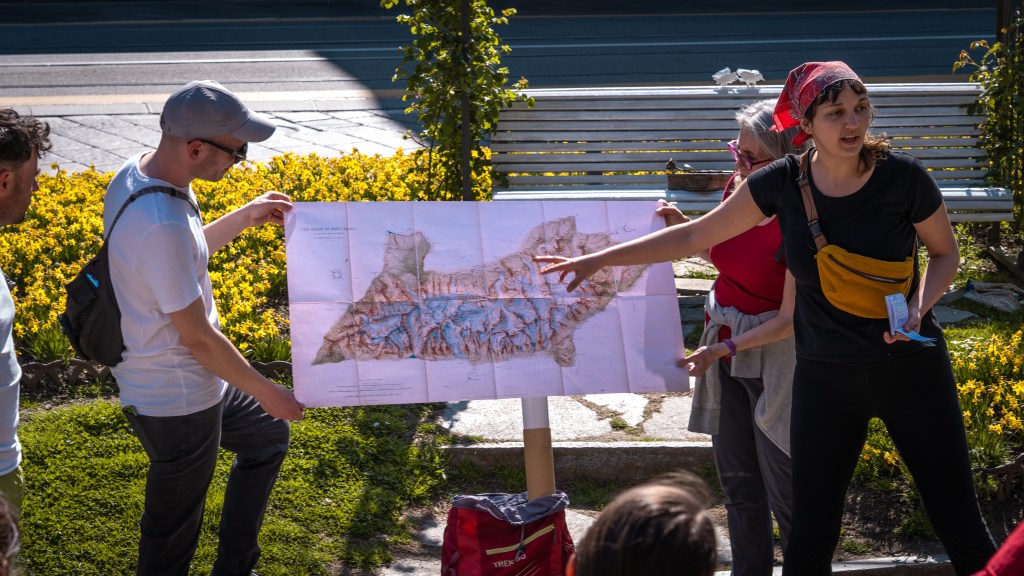 Participants walk through the streets of Turin during The March of the Glaciers, an itinerant performance by Sibylle Duboc as part of the Walking Mountains Social Walks program.