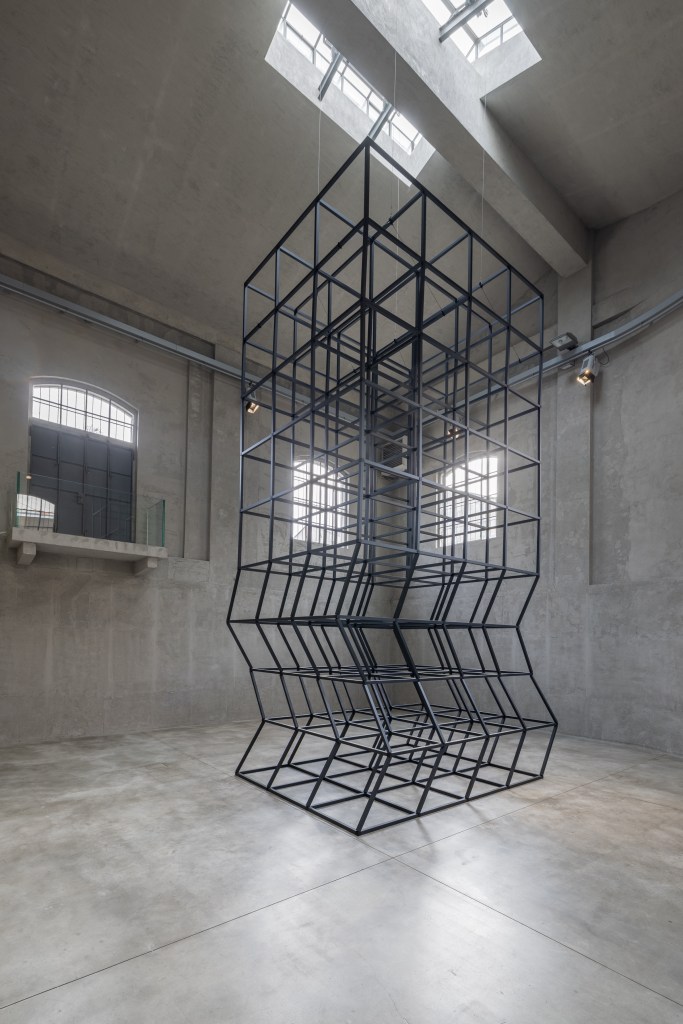 Installation view of Mona Hatoum’s All of a Quiver (2022), a kinetic structure of metal elements activated by a motor within the gallery space.