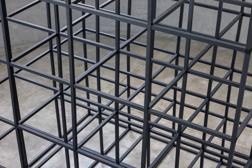 Installation view of Mona Hatoum’s All of a Quiver (2022), a kinetic structure of metal elements activated by a motor within the gallery space.