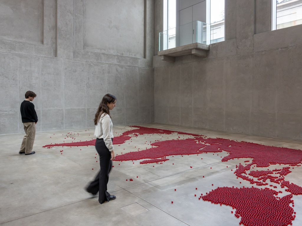 Installation view of Mona Hatoum’s Map (red) (2026), composed of numerous small red glass spheres arranged across the floor to form a map-like configuration