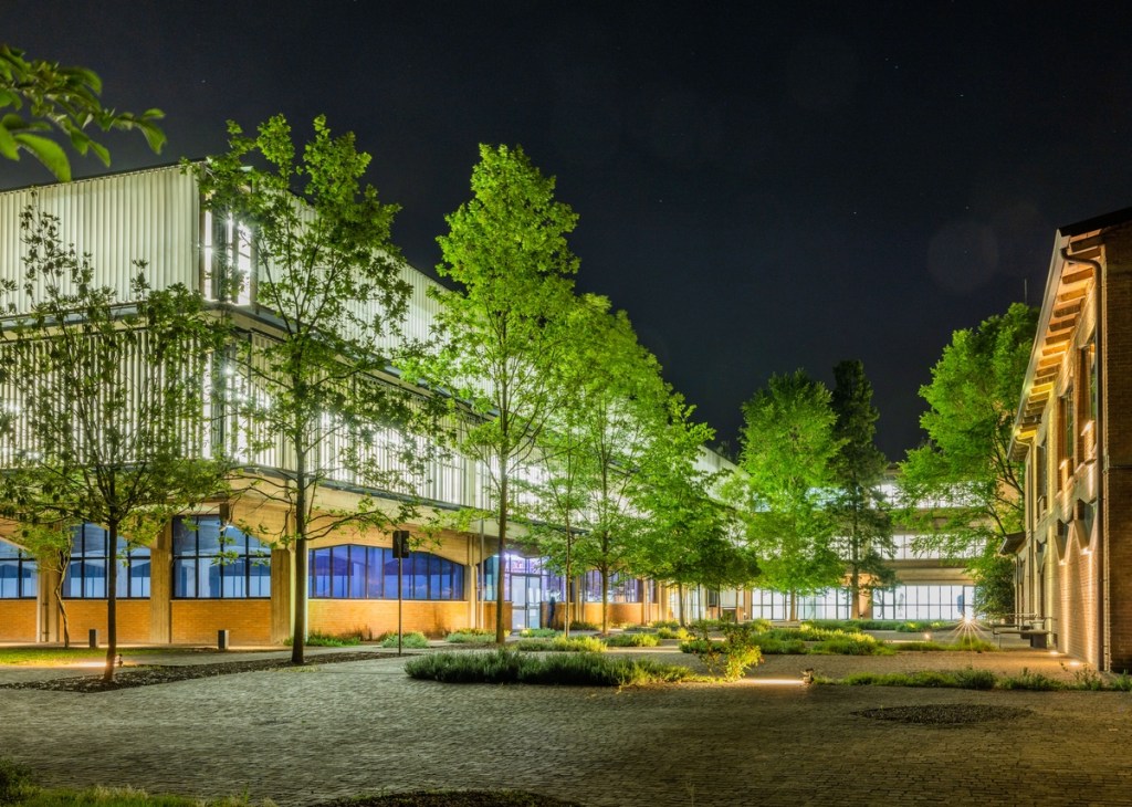 Courtyard and Pattern Room project space at Collezione Maramotti viewed at night.