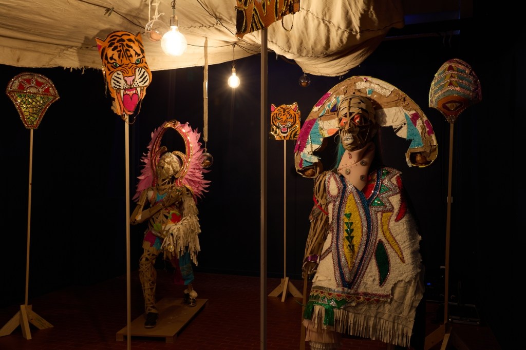 Lavar Munroe (with John Beadle), However Long the Night, the Dawn Will Break (2026), site-specific installation incorporating salvaged Junkanoo costumes, used Bahamian newspapers, mixed media, and materials from John Beadle's studio