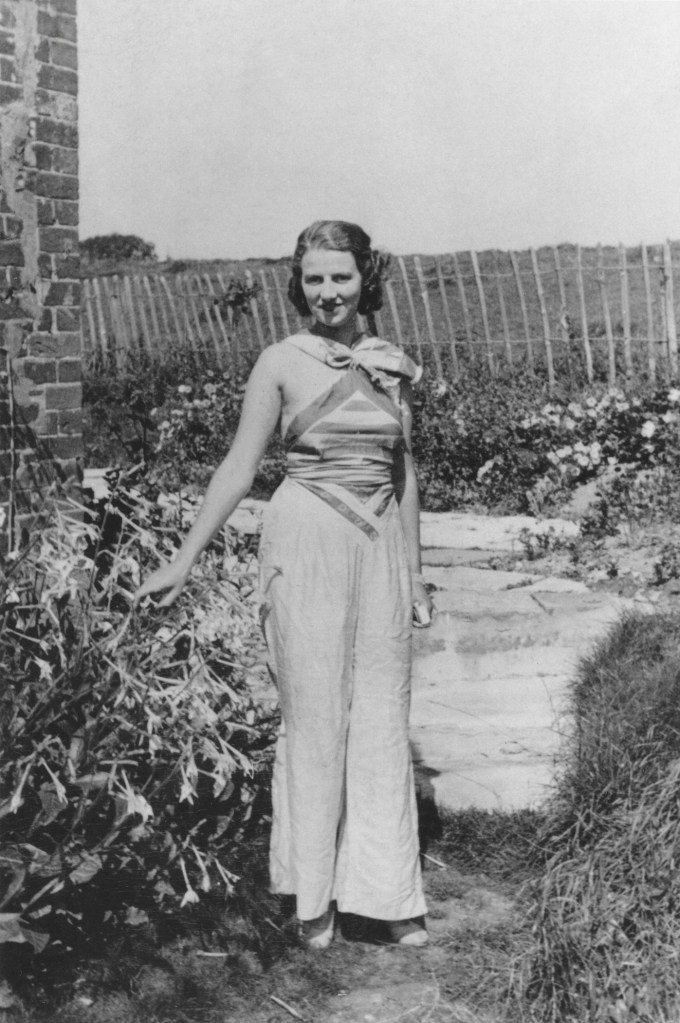 Black-and-white archival photograph of Peggy Guggenheim standing at Hayford Hall around 1934, capturing the collector in an informal setting during the early years of her collecting career