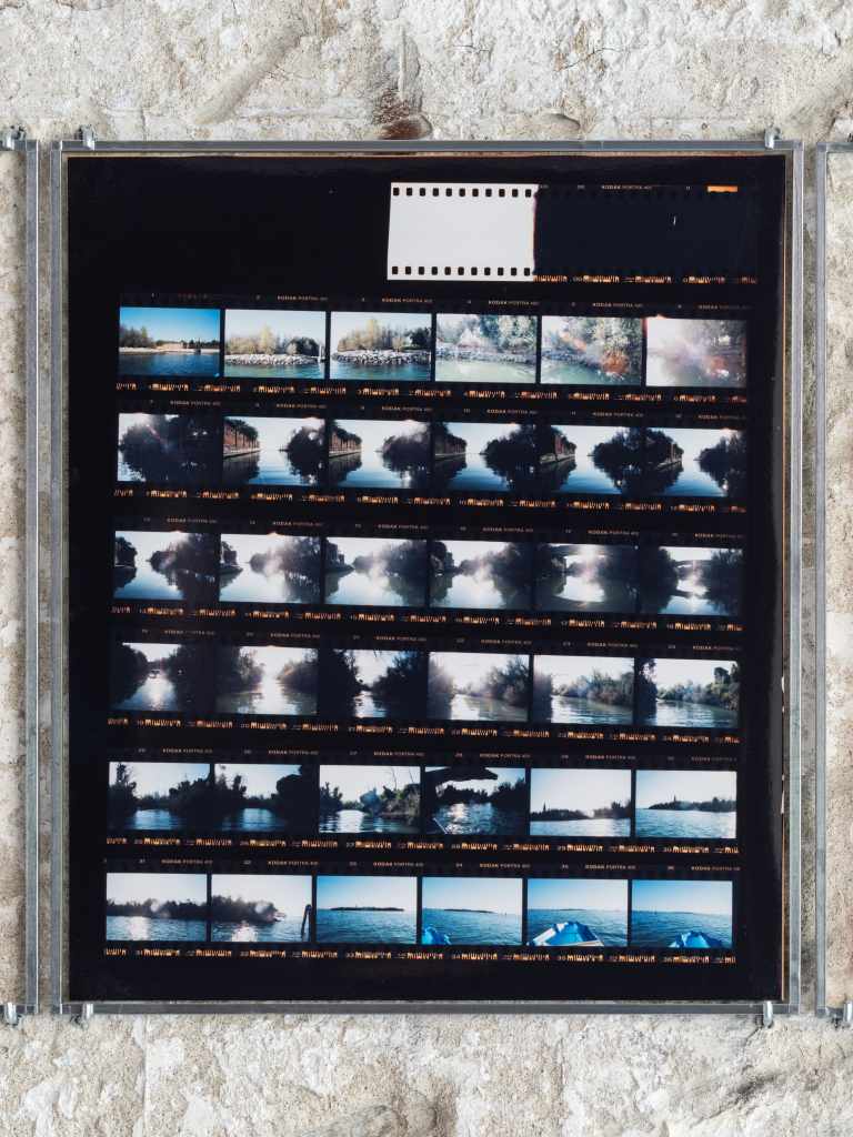 324 Photos: Hundreds of small photographs arranged in a dense grid, documenting locations across Venice and nearby islands, creating a visual archive of places and everyday scenes