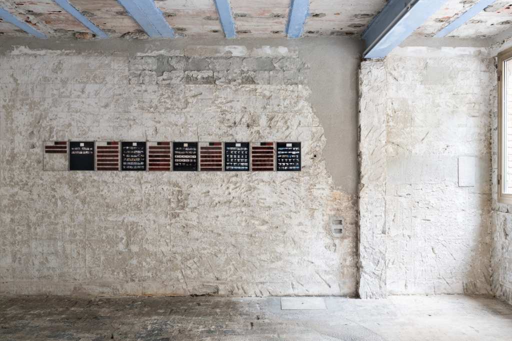 324 Photos: Hundreds of small photographs arranged in a dense grid, documenting locations across Venice and nearby islands, creating a visual archive of places and everyday scenes
