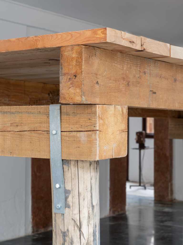 (45.3820696, 12.3294242): A close-up view of the artwork featuring geographic coordinates presented as a minimalist installation, emphasizing location through text and spatial placement.