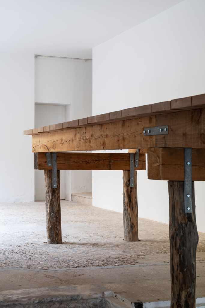 (45.3820696, 12.3294242): A close-up view of the artwork featuring geographic coordinates presented as a minimalist installation, emphasizing location through text and spatial placement.