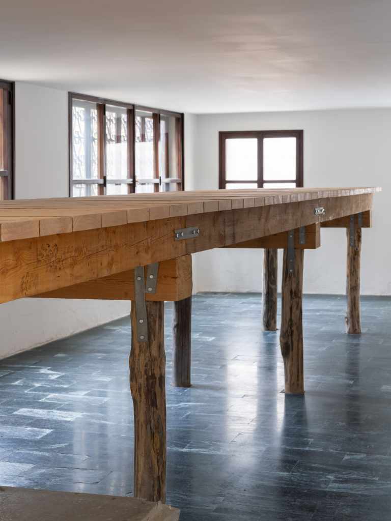 (45.3820696, 12.3294242): A close-up view of the artwork featuring geographic coordinates presented as a minimalist installation, emphasizing location through text and spatial placement.