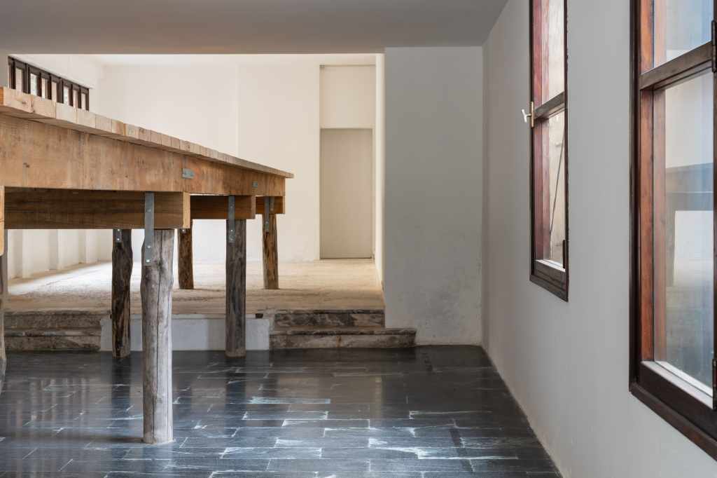 (45.3820696, 12.3294242): A close-up view of the artwork featuring geographic coordinates presented as a minimalist installation, emphasizing location through text and spatial placement.