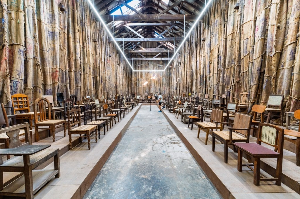 Installation view of Ibrahim Mahama’s Parliament of Ghosts at the 2025 Kochi-Muziris Biennale in Kochi, India
