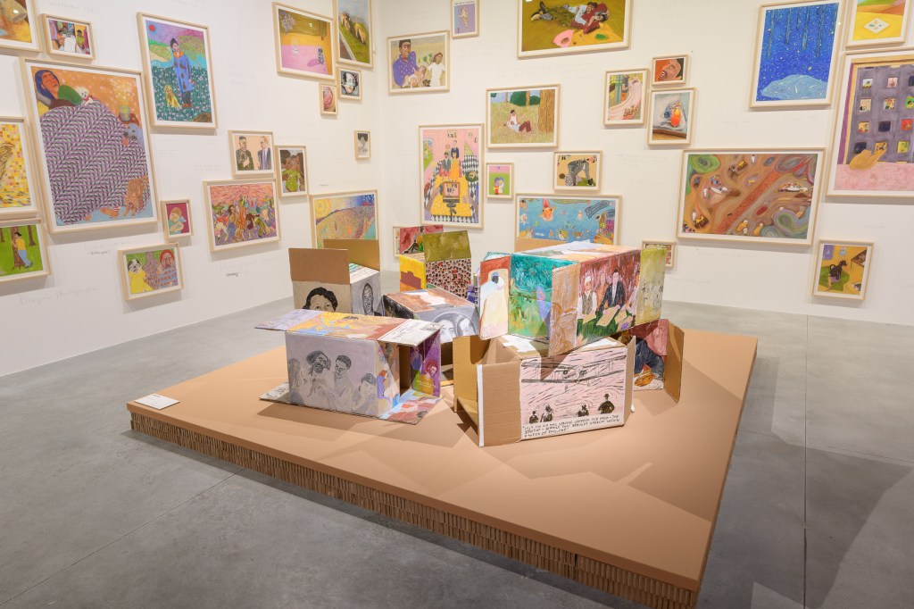 Sohrab Hura, Timelines, 2024. Nine small acrylic-and-gesso paintings on corrugated cardboard boxes, depicting Bees, Delhi, Mail, Mother, Protest, Sheila, The Bus, The Olive Tree, and The School. Each work measures 35 × 30 cm. Presented in the 61st International Art Exhibition – La Biennale di Venezia, In Minor Keys. Photo by Andrea Avezzù. Courtesy of La Biennale di Venezia.